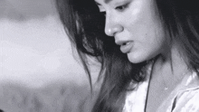 a close up of a woman 's face in a black and white photo