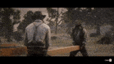 a man in a cowboy hat is standing next to another man holding a large piece of wood ..