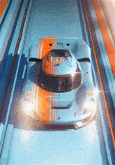 a blue and orange racing car with the word porsche on the front