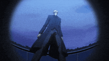 a man in a black coat stands in the dark