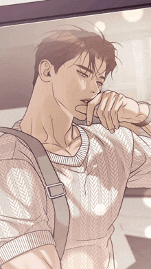 a man wearing a sweater with a strap around his neck