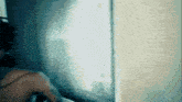 a blurry picture of a person standing in front of a wall