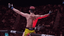 a man in yellow shorts with the word venum on the back