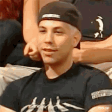 a man wearing a hat and a t-shirt with the word slayer on it .
