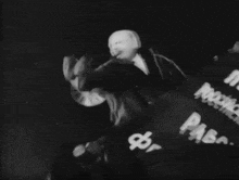 a black and white photo of a man wearing a mask with russian writing