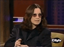 a man wearing sunglasses and a black jacket is on a citytv channel