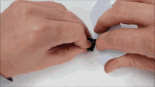 a person is holding a bunch of black beads in their hand