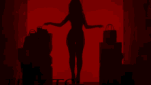 a silhouette of a woman in a red room