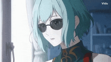 a girl with blue hair is wearing sunglasses and a vidu logo in the background
