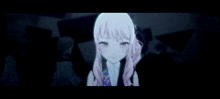 a girl with white hair and pink eyes is standing in the dark and smiling .