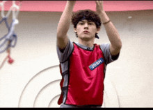 a young man wearing a red jersey with the name josh on the front