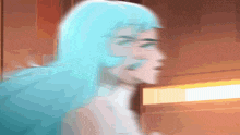 a blurry image of a woman with blue hair