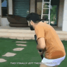 a man is playing tennis in a backyard with the words `` they finally left their basements '' written below him .