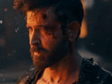 a man with a beard and a bullet hole in his forehead