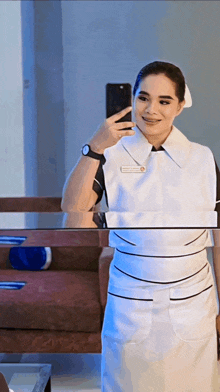 a nurse taking a selfie in front of a mirror