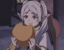 a girl with white hair and ears is holding a hamburger in her hands