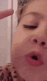 a close up of a child making a funny face with her mouth open