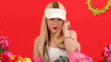 a woman wearing a white visor and red lipstick