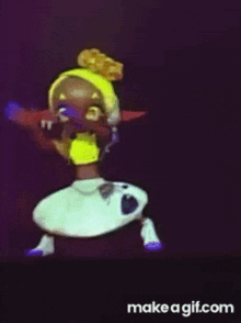 a cartoon character with a yellow headband and a white skirt is dancing on a make a gif.com website