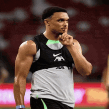 a man wearing a nike tank top with a axa logo on it