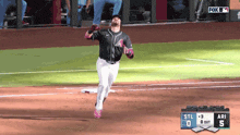 a baseball player is running on the field with a fox broadcast behind him