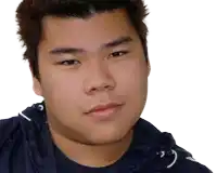 a close up of a young man 's face with a blue shirt