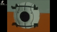 a white object with a black hole in the middle is sitting on top of a table .