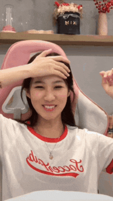 a woman wearing a t-shirt that says mix on it smiles