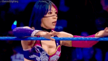 a female wrestler is giving a thumbs up in a wrestling ring