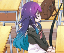a girl with purple and blue hair sits at a desk