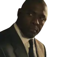 a man wearing a suit and tie looks at the camera