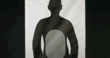 a black and white drawing of a man with a circle in the middle