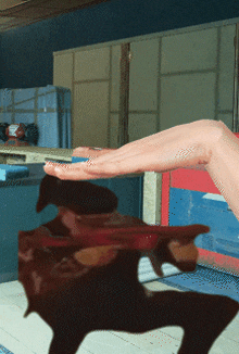 a person 's hand is reaching out towards a cartoon character