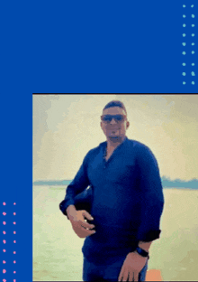 a man wearing sunglasses and a blue shirt is standing on a beach