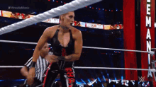 a woman is standing in a wrestling ring with the words wrestlemania on the ropes behind her