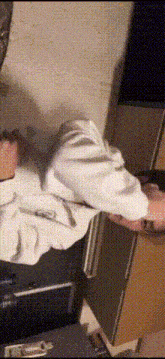 a person is laying on a bed with a blanket on their head