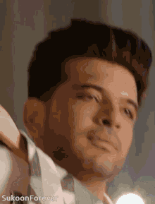 a close up of a man 's face with the words sukoon forever on the bottom right
