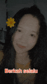 a girl with a yellow flower in her hair and the words berkah selalu