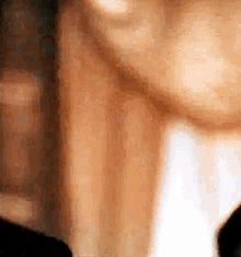 a close up of a man 's face with a blurred background .