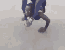 a person is doing a handstand on a white floor