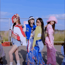 a group of girls are posing for a picture with one wearing a blue jacket that says ' ec ' on the front