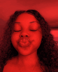 a woman with her eyes closed making a face with her lips