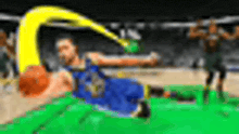 a blurry picture of a basketball player laying on the floor .