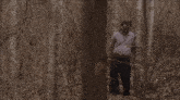 a man in a blindfold is standing in a forest