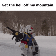 a robot holding a gun and a shield in the snow with the words get the hell off my mountain