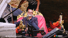 a man is sitting in a gondola with a nbc destination x logo on the bottom