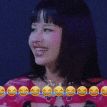 a woman in a pink dress is surrounded by laughing faces