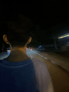 a blurry picture of a person walking down a road at night