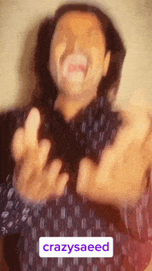 a man with long hair and a mustache is making a funny face with the words crazysaeed above him