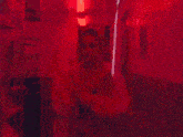 a woman in a pink jacket stands in front of a red door